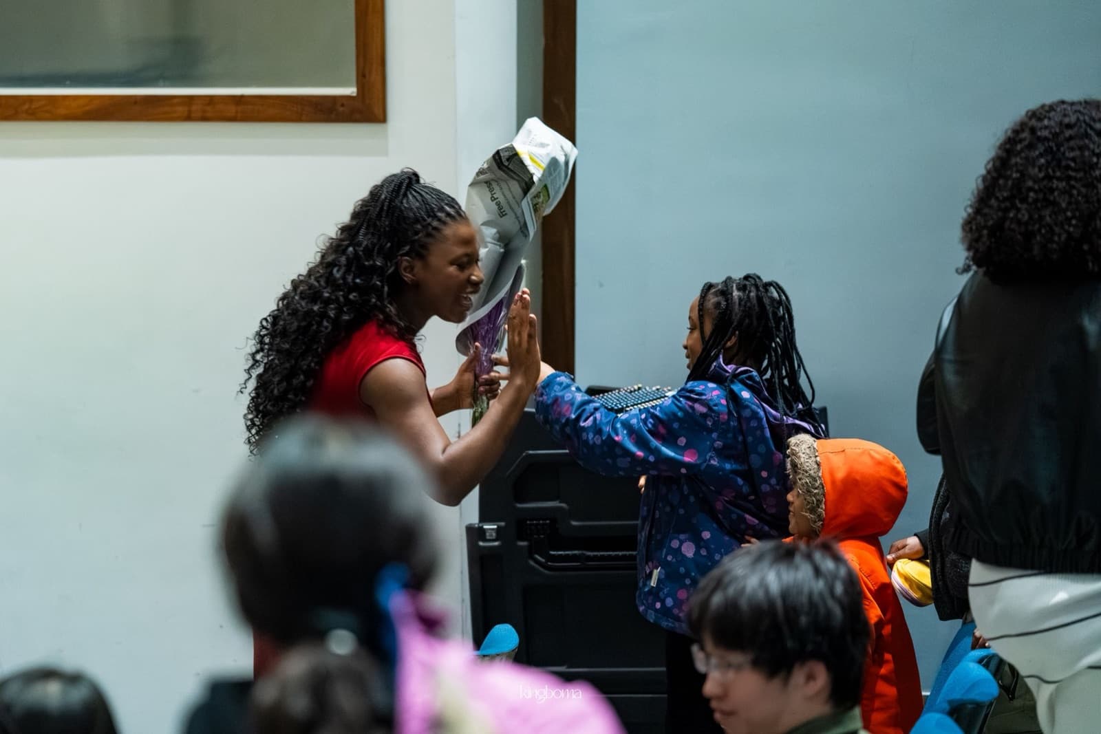 Young students greeting their teacher after a recital